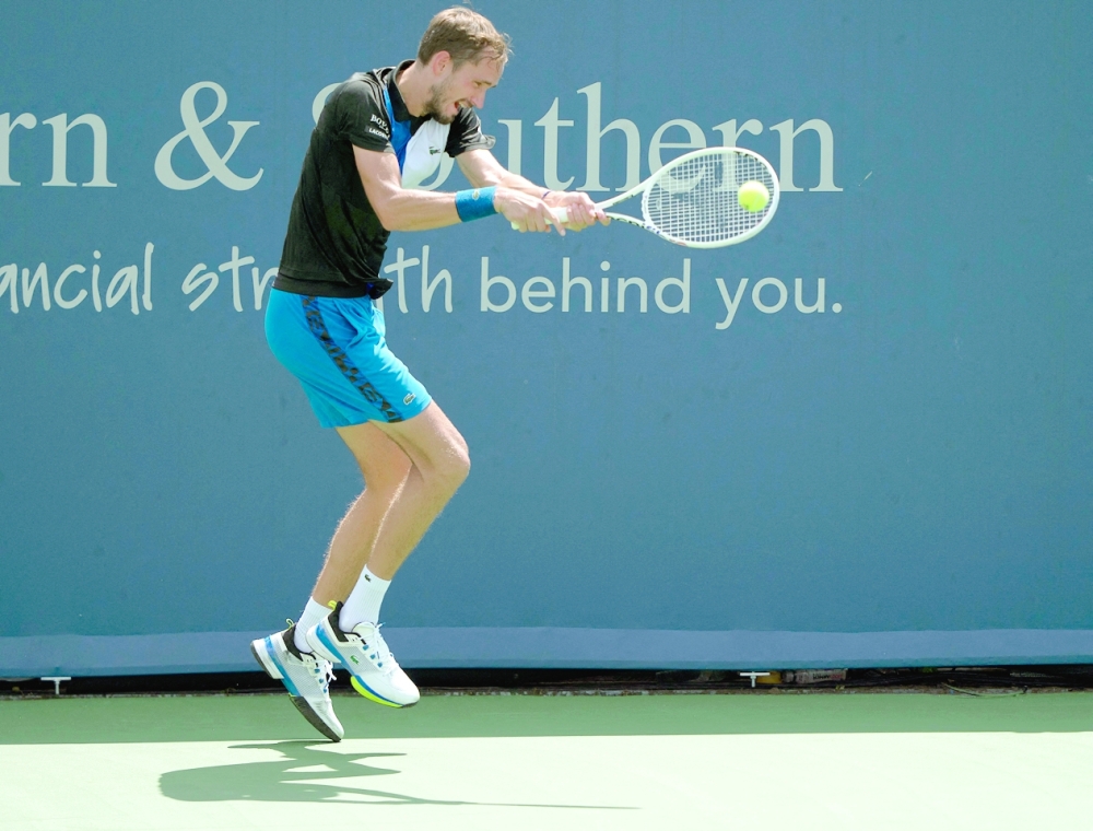 Daniil Medvedev (RUS) returns a shot during his match against Denis Shapovalov (CAN) at the Western & Southern Open at the at the Lindner Family Tennis Center. -- USA TODAY Sports
