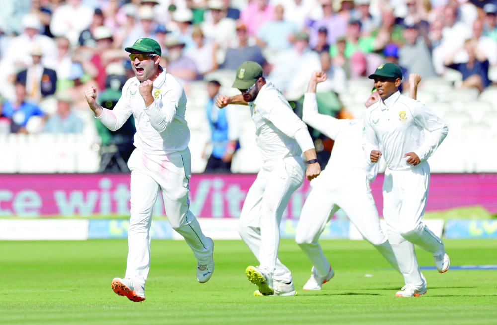 South Africa's Dean Elgar celebrates with team-mates after winning the first Test. -- Reuters