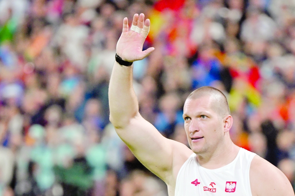 Poland's Wojciech Nowicki celebrates winning gold in the men's Hammer Throw final during the European Athletics Championships at the Olympic Stadium in Munich, southern Germany on August 18, 2022. (Photo by ANDREJ ISAKOVIC / AFP)

