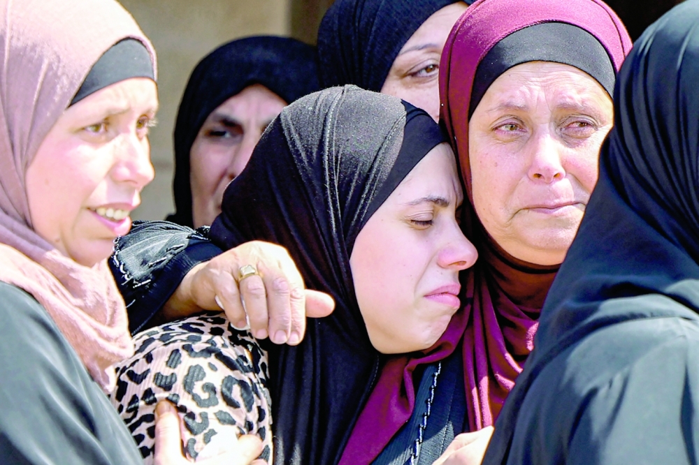 Relatives mourn during the funeral of Palestinian Salah Sawafta. - AFP