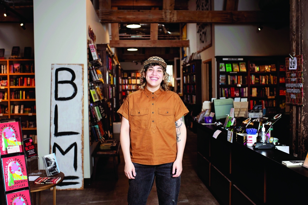 Fawzy Taylor, the social media and marketing manager of A Room of Ones Own, a bookstore in Madison, Wis., created graphics to help overwhelmed readers. (Melanie Renee Photography via The New York Times)