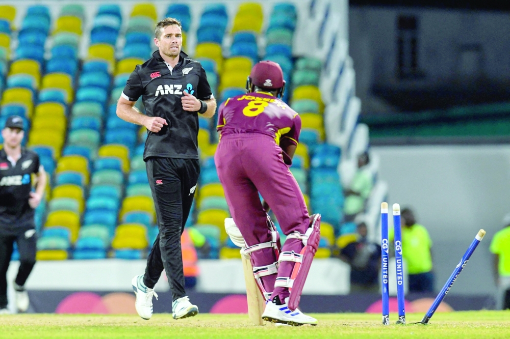 Tim Southee (L) of New Zealand celebrates the dismissal of Alzarri Joseph (R) of West Indies during the 2nd ODI match between West Indies and New Zealand at the Kensington Oval in Bridgetown, Barbados, on August 19, 2022. (Photo by Randy Brooks / AFP)

