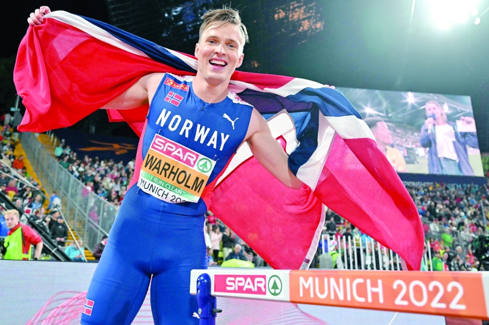 Norway's Karsten Warholm celebrates gold after the men's 400m Hurdles final during the European Athletics Championships at the Olympic Stadium in Munich, southern Germany on August 19, 2022.  (Photo by ANDREJ ISAKOVIC / AFP)
