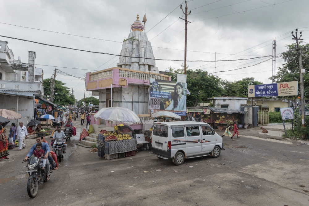 People walk about Randhikpur, India, Aug. 19, 2022. 