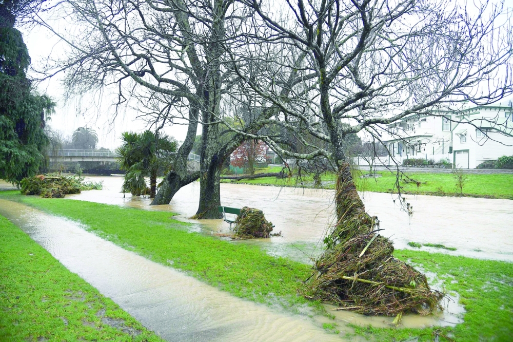 Water is seen on the sidewalks after the Maitai river burst its banks in Nelson as the city experienced flash floods caused by a storm. - AFP
