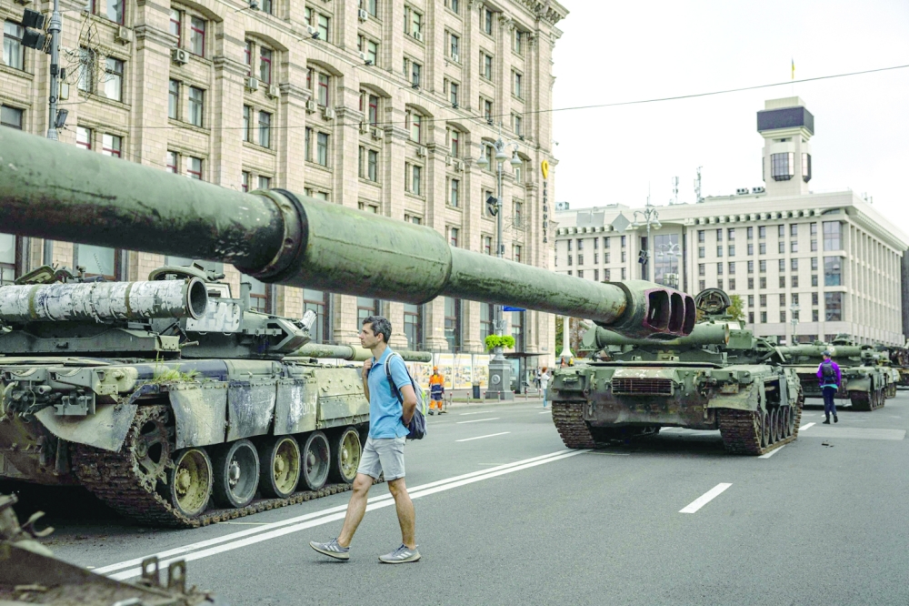 A man looks at destroyed Russian military equipment at Khreshchatyk street in Kyiv. -- AFP