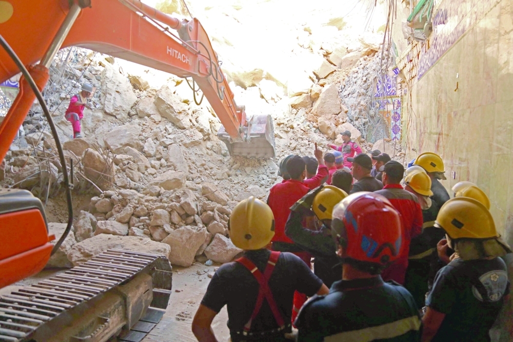 Iraqi rescue workers search for survivors trapped under the rubble of the Qattarat al Imam Ali shrine following a landslide, on the outskirts of Karbala. - AFP 