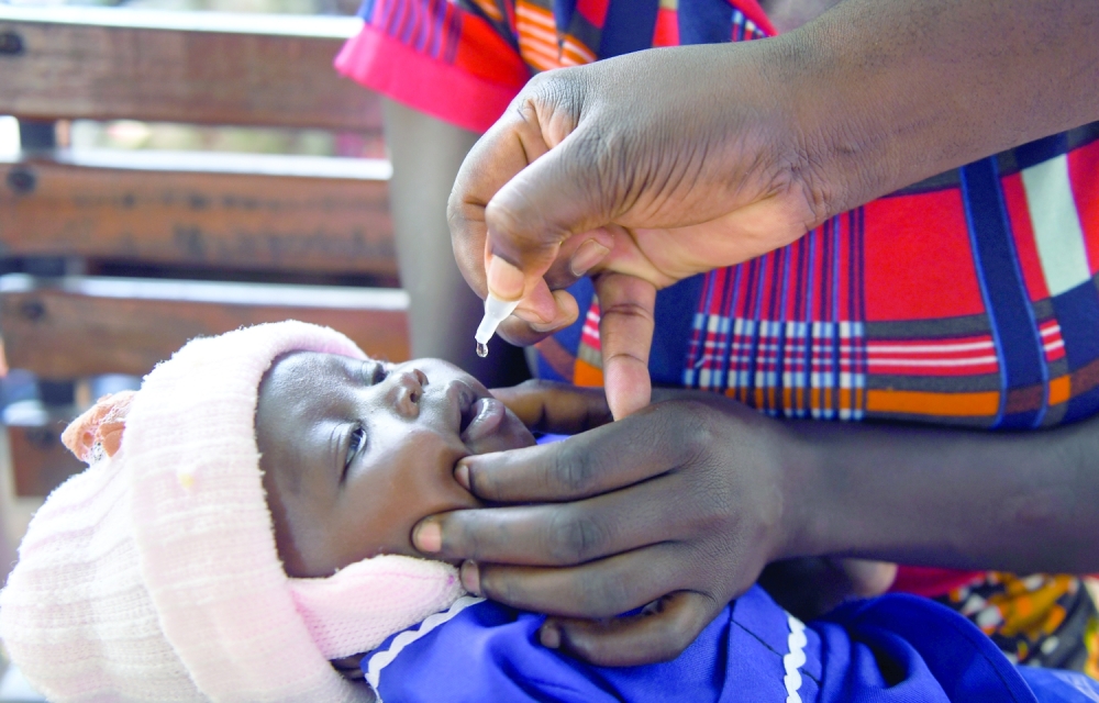 Charles Bizimaki administers a polio vaccine at the Makhwira Health Center in Chikwawa, Malawi.

