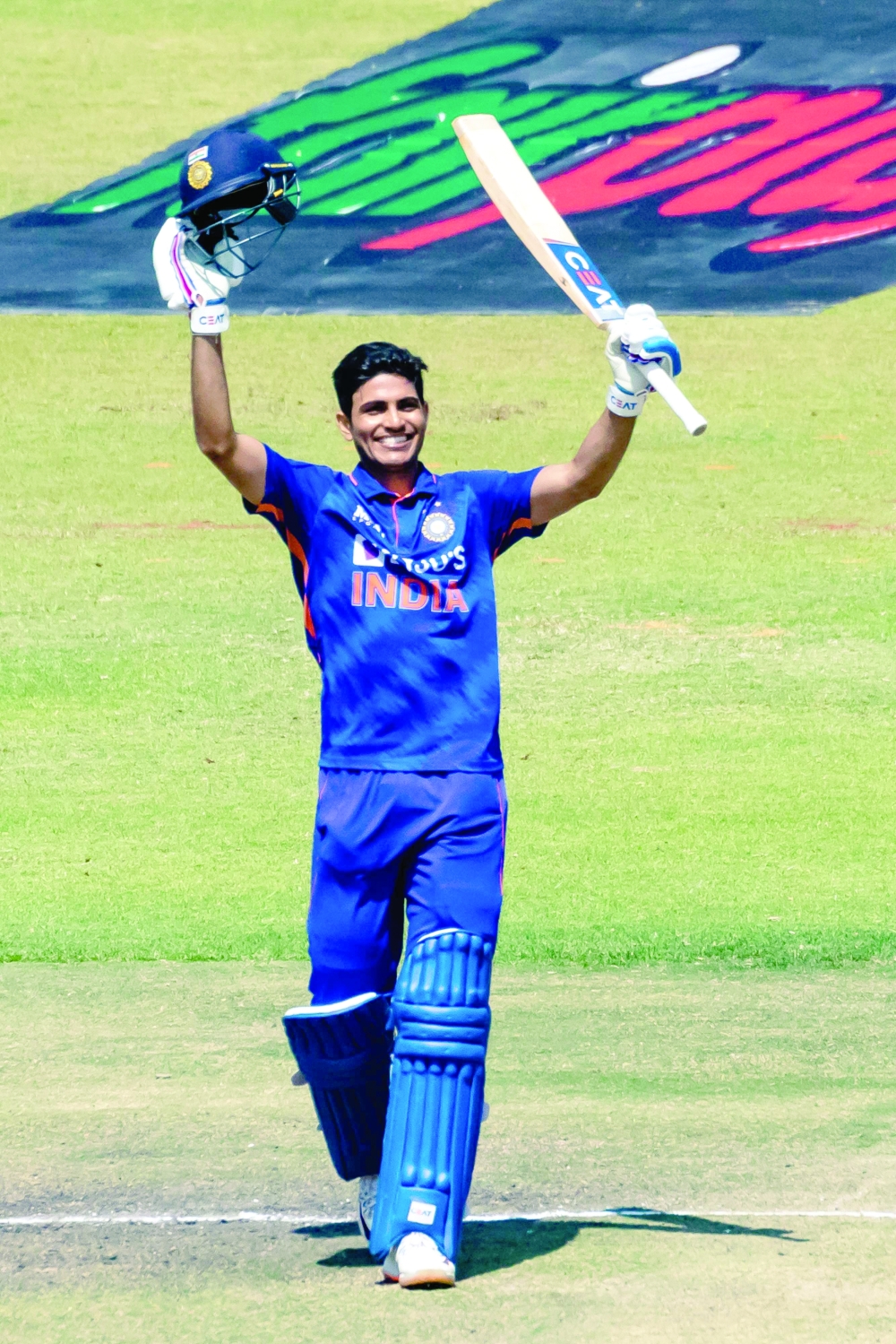 India's Shubman Gill celebrates after scoring a century (100 runs) during the third one-day international (ODI) cricket match between Zimbabwe and India at the at the Harare Sports Club in Harare on August 22, 2022. (Photo by Jekesai NJIKIZANA / AFP)

