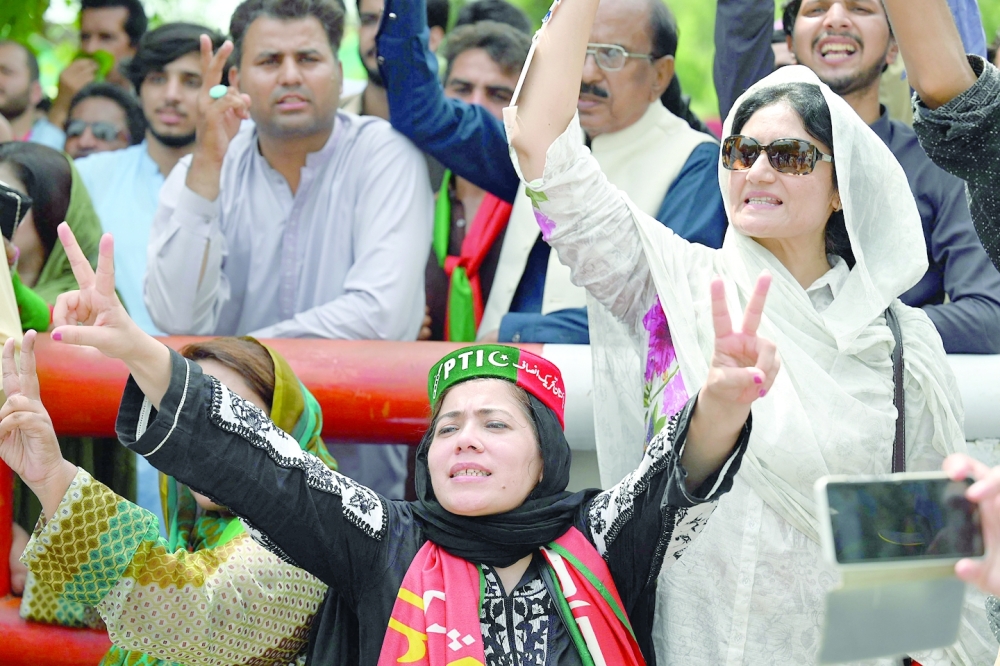 Supporters of Pakistan's former prime minister Imran Khan shout slogans as they guard outside the Khan's residence in Islamabad. -- AFP