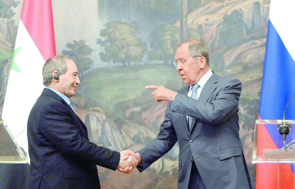 Russia's Foreign Minister Sergei Lavrov (R) with his Syrian counterpart Faisal Mekdad during a press conference following their talks in Moscow on Tuesday. -- AFP