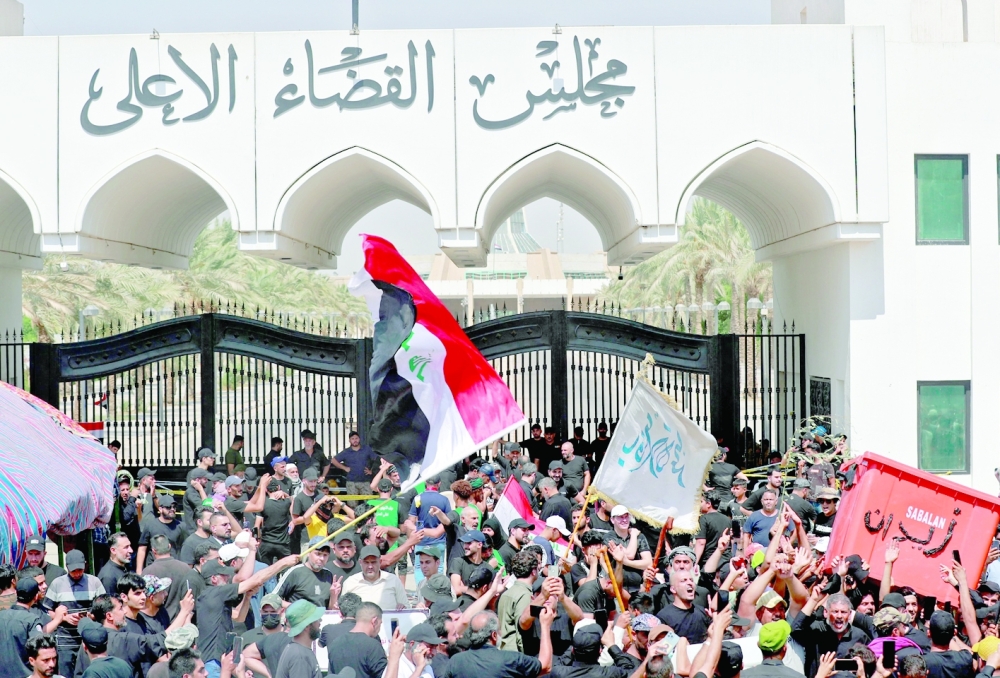 Supporters of Moqtada Sadr gather outside the headquarters of the Supreme Judicial Council in Baghdad on Tuesday. -- AFP