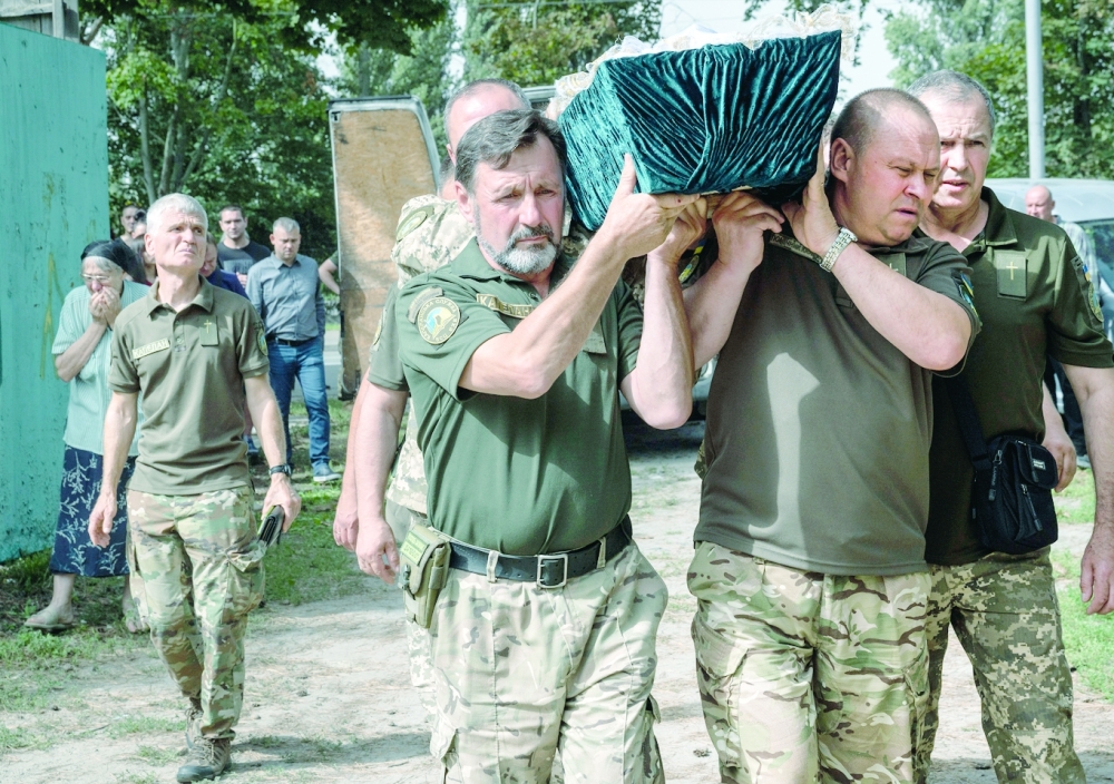 Family members and mourners gather at the funeral for Ukrainian soldier Oleg Marinchenko in Kyiv on Tuesday.