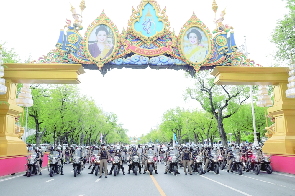 Police block the road as protesters gather after the Constitutional Court suspended Prime Minister Prayuth Chan-ocha from official duties, in Bangkok on Wednesday. - Reuters