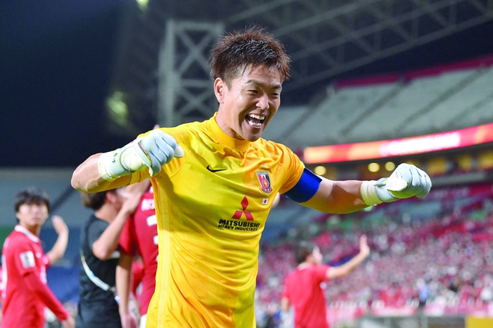 Urawa Reds' Japanese goalkeeper Shusaku Nishikawa celebrates at the end of the AFC Champions League semi-final football match between South Korea's Jeonbuk Hyundai Motors FC and Japan's Urawa Red Diamonds in Saitama, on August 25, 2022.  (Photo by Kazuhiro NOGI / AFP)

