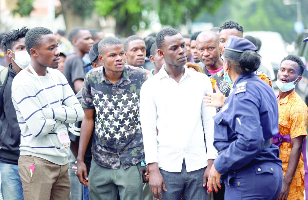 A police officer gestures while talking to locals as Angola's election commission says ruling MPLA party leads with 52 per cent majority, after the general election close in Luanda, Angola on Thursday. -- Reuters