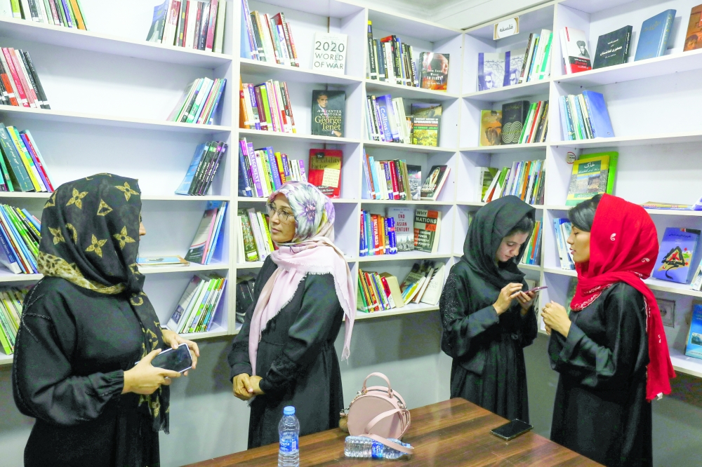 Afghan women attend the inauguration of women's library in Kabul. - Reuters