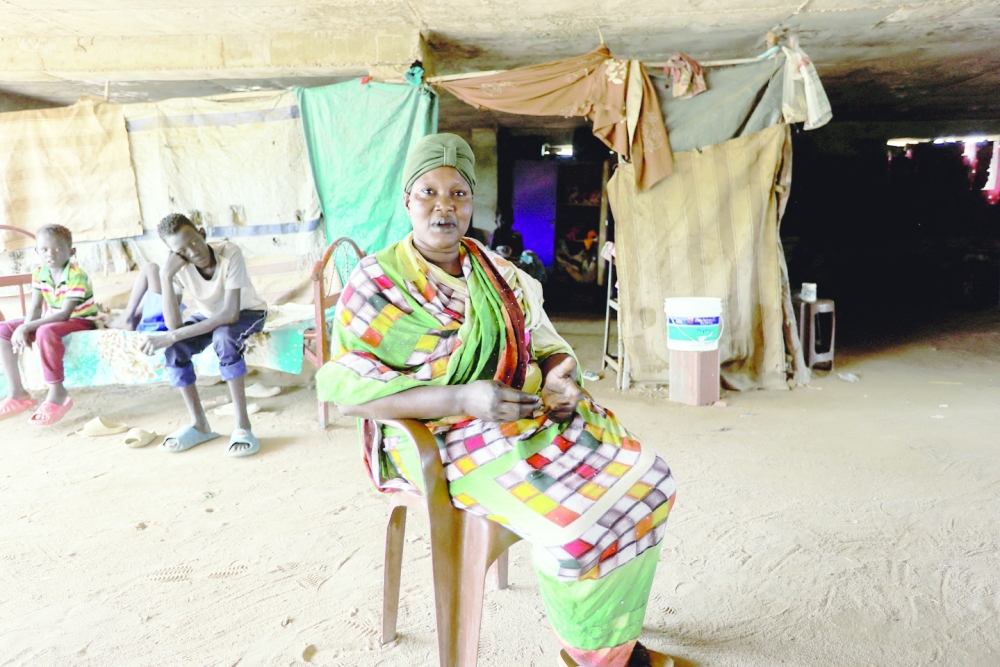 South Sudanese Toka Ayman Agok, who returned to Khartoum after the 2011 secession, looks on during an interview with Reuters, at a makeshift shelter in an abandoned plot of land, in Bahri, Sudan.