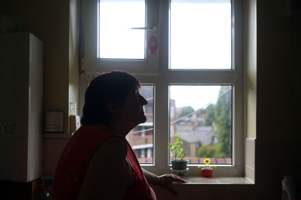 Pensioner Diane Skidmore stands next to the boiler in her kitchen in London on August 25, 2022.  Britain announced a vast 80-percent hike in electricity and gas bills, in a dramatic worsening of the cost-of-living crisis before winter as the UK awaits a new leader.