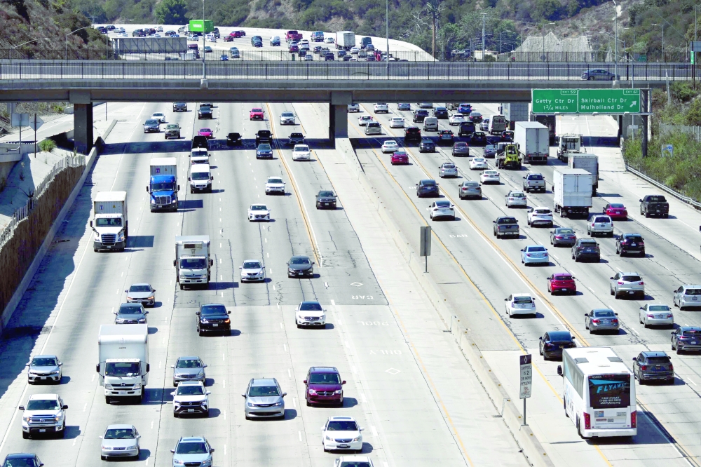 Cars, trucks, SUVs, and other vehicles drive in traffic on the 405 freeway through the Sepulveda Pass in Los Angeles, California. - AFP