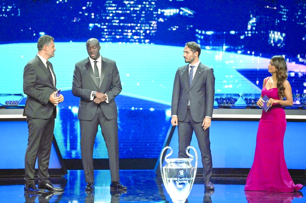 (L/R): UEFA Managing Director of Communications Pedro Pinto, former Ivorian midfielder Yaya Toure, former Turkish player Hamit Altintop and British journalist Reshmin Chowdhury speak on stage ahead of the draw for the UEFA Champions League football tournament 2022-2023 in Istanbul on August 25, 2022. (Photo by OZAN KOSE / AFP)

