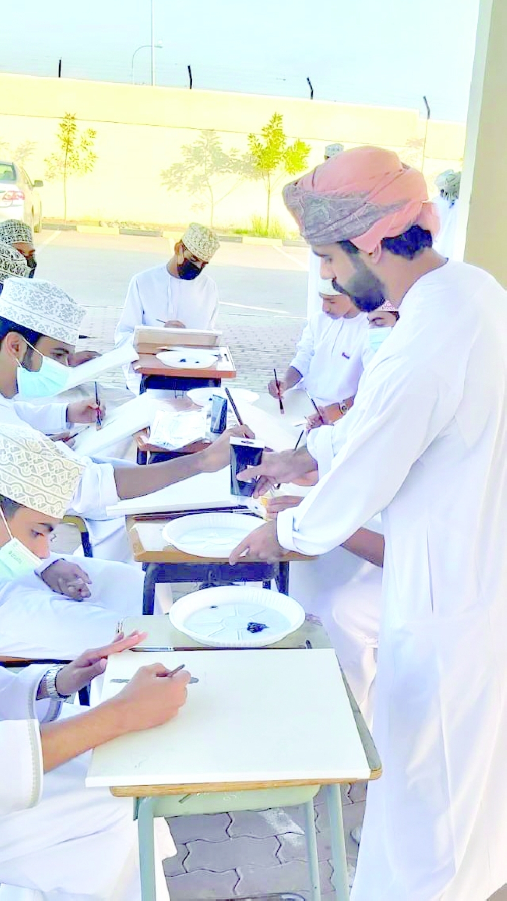 Majid al Amri teaching students nuances of art