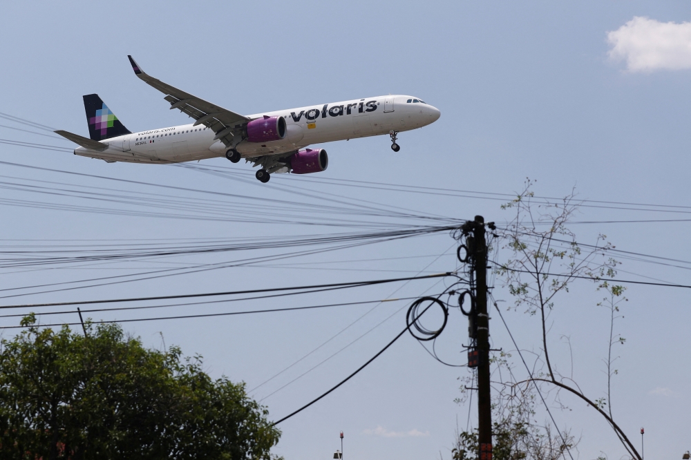  A Volaris airplane prepares to land on the airstrip at Benito Juarez international airport in Mexico City, Mexico