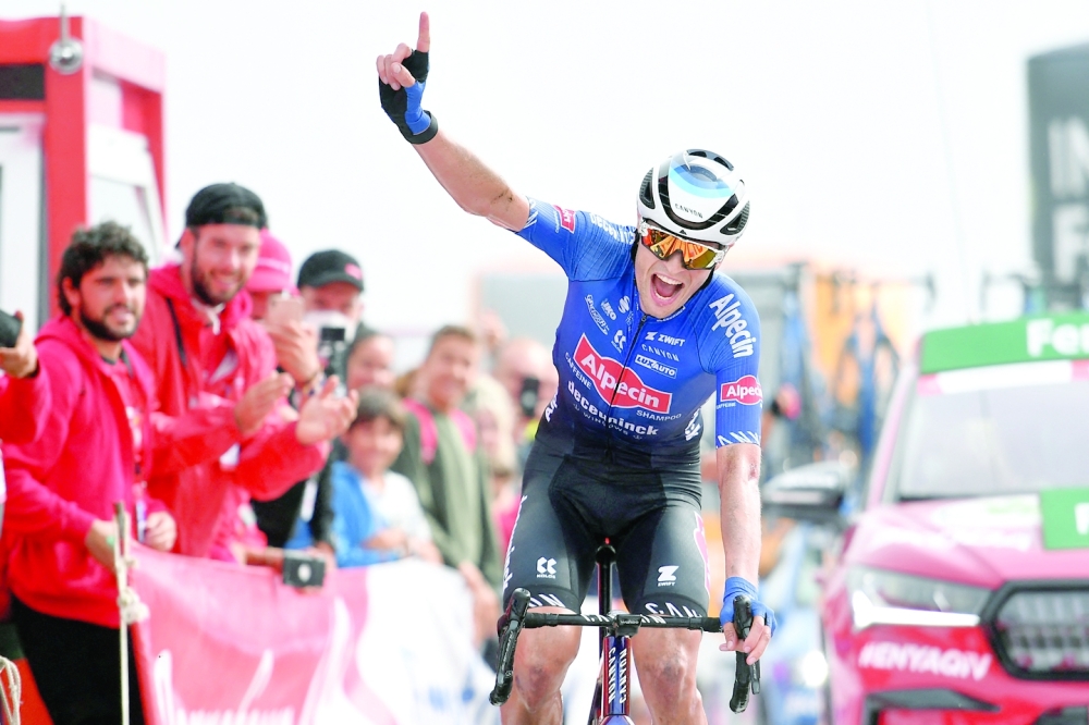 Team Alpecin-Deceuninck's Australian rider Jay Vine celebrates crossing the finish line in first place during the 8th stage of the 2022 La Vuelta cycling tour of Spain, a 153.4 km race from Pola de Laviana to Collau Fancuaya - Yernes y Tameza, on August 27, 2022. (Photo by ANDER GILLENEA / AFP)

