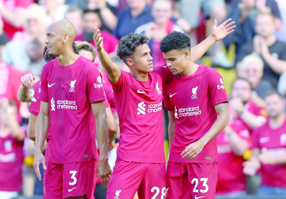 Soccer Football - Premier League - Liverpool v AFC Bournemouth - Anfield, Liverpool, Britain - August 27, 2022   Liverpool's Fabio Carvalho celebrates scoring their eighth goal with Luis Diaz and Fabinho REUTERS/Phil Noble EDITORIAL USE ONLY. No use with unauthorised audio, video, data, fixture lists, club/league logos or 'live' services. Online in-match use limited to 75 images, no video emulation. No use in betting, games or single club /league/player publications.  Please contact your account representative for further details.