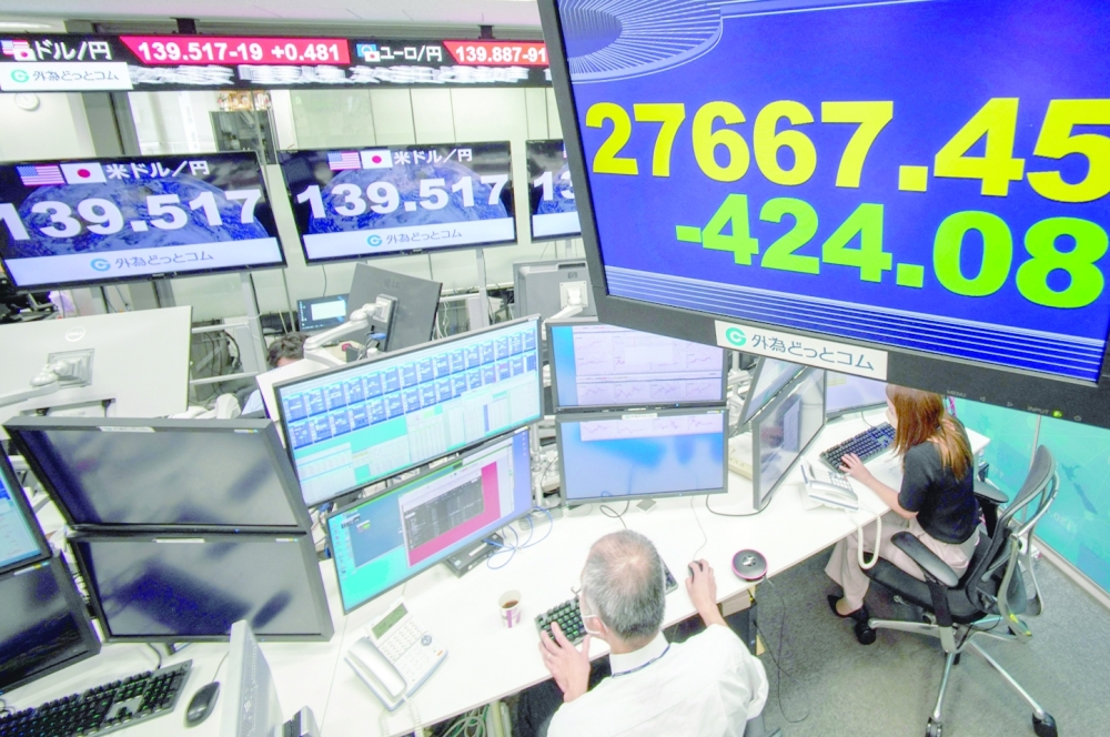 An electronic quotation board displays the share price of the Tokyo Stock Exchange (top R) at a foreign exchange brokerage in Tokyo on Thursday. -- AFP