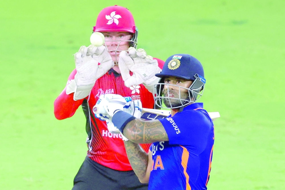 India's Suryakumar Yadav (R) plays a shot during the Asia Cup Twenty20 international cricket match between India and Hong Kong at the Dubai International Cricket Stadium in Dubai on August 31, 2022. (Photo by KARIM SAHIB / AFP)

