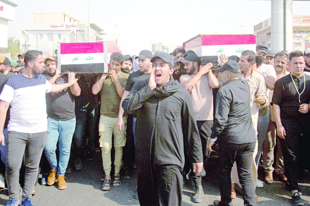Iraqi mourners attend the funeral of two Saraya al Salam fighters, an armed faction linked to Moqtada Sadr, in Basra on Thursday. - AFP