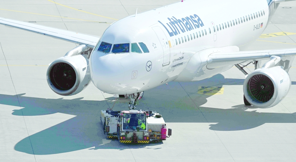 A Lufthansa plane is being pulled onto the tarmac at the Franz-Josef-Strauss airport in Munich, southern Germany, on September 2, 2022, as pilots called for a strike affecting the Lufthansa passenger airline and Lufthansa Cargo after pay negotiations with the German airline collapsed. German airline group Lufthansa said it is cancelling "almost all" of its flights to and from its main German hubs in Munich and Frankfurt on September 2, 2022 after pilots called a strike. (Photo by Christof STACHE / AFP)
