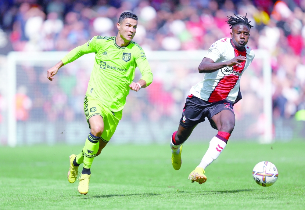 Southampton's Mohammed Salisu in action with Manchester United's Cristiano Ronaldo. -- Reuters