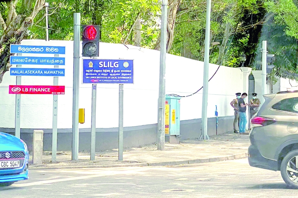 Members of Sri Lanka police personnel stand guard near a government residence prepared to accommodate deposed former president Gotabaya Rajapaksa. -- AFP