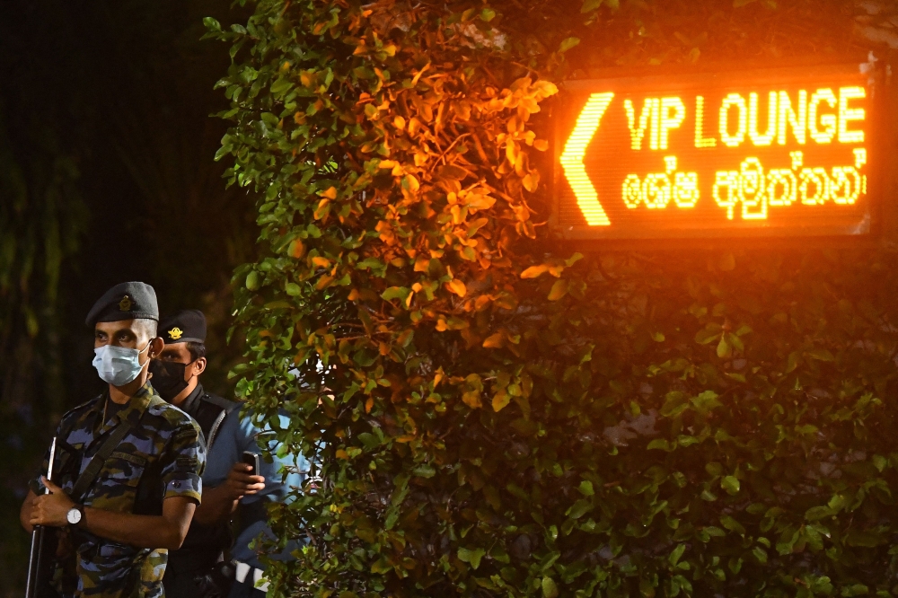 Air force personnel stand guard at the entrance of Bandaranaike International Airport in Colombo on early September 3, 2022. 