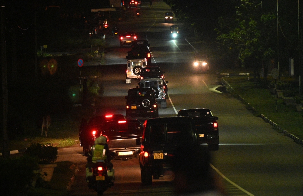 A convoy of vehicles said to be transporting former Sri Lankan President Gotabaya Rajapaksa convoy leaves Bandaranaike International Airport in Colombo early September 3,