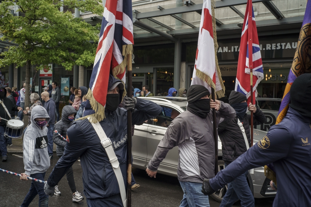 Loyalists marching to protest trade rules that require border checks on goods flowing from mainland Britain to the North, as part of a Brexit deal with the European Union, in Portadown, Northern Ireland, on June 5, 2021. (Paulo Nunes dos Santos/The New Yo