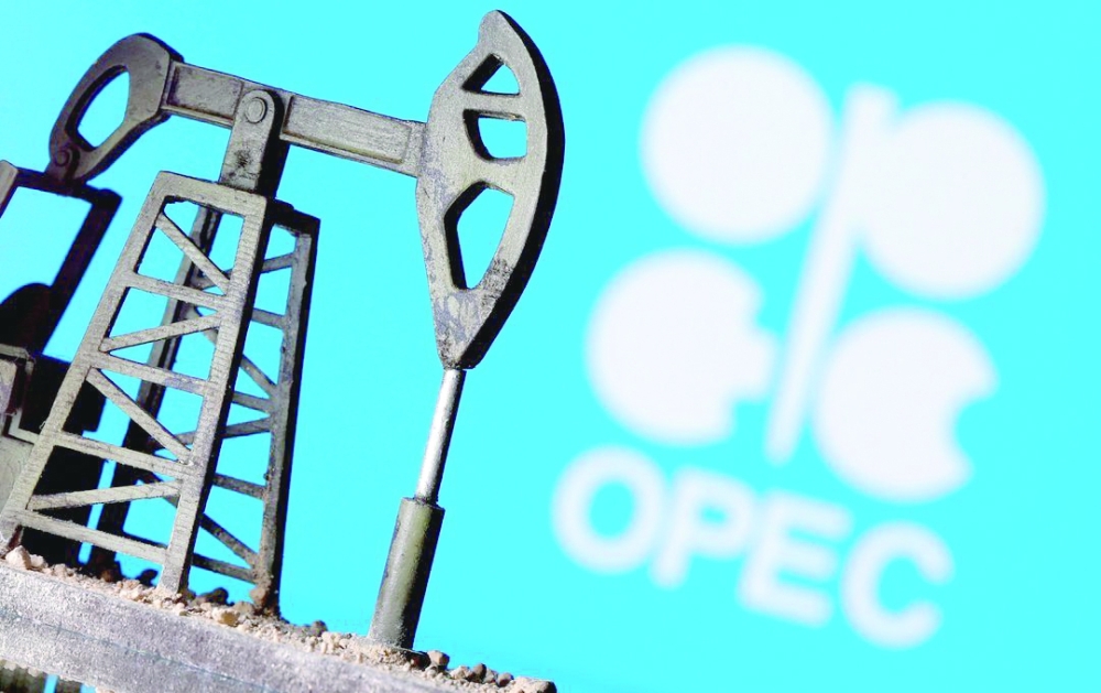A 3D printed oil pump jack is seen in front of displayed Opec logo in this illustration picture. — Reuters