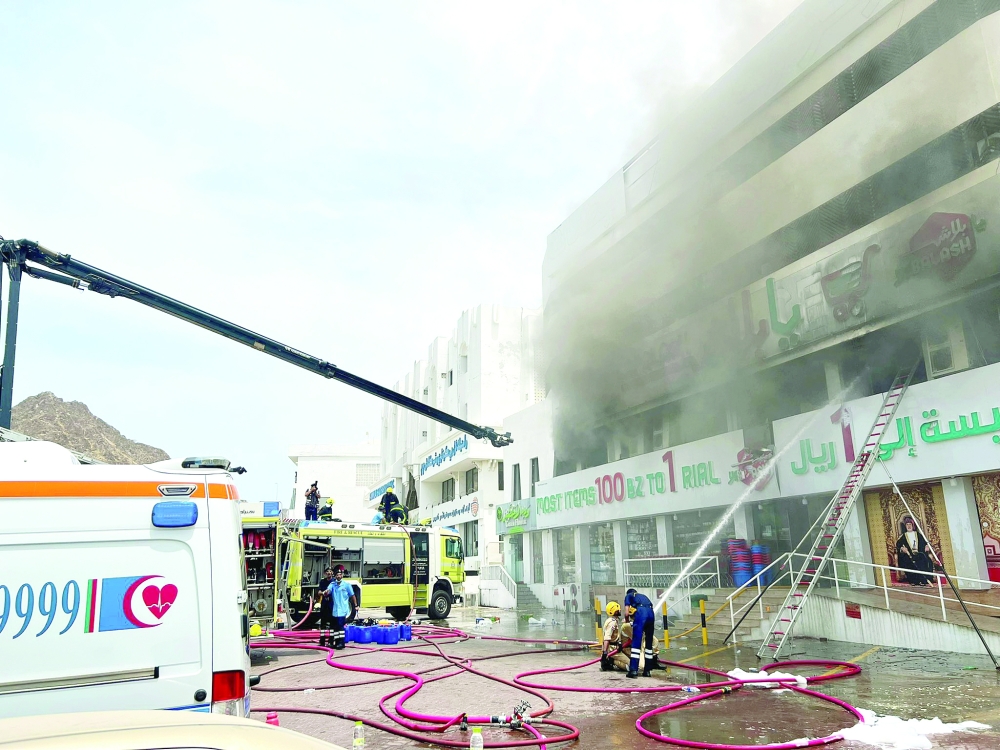 The firefighting teams of the Civil Defense and Ambulance Authority extinguish fire that broke out in a building in Muttrah.