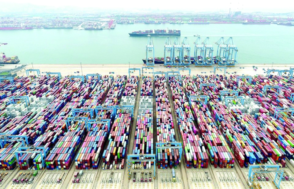 An aerial view shows containers and cargo vessels at the Qingdao port in Shandong province, China. — Reuters