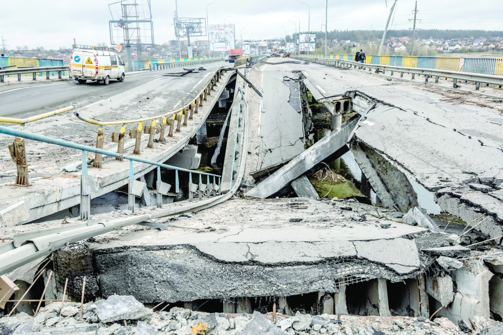 The wreckage of a bombed bridge across the Irpin River in Bucha, Ukraine, near Kyiv. 
