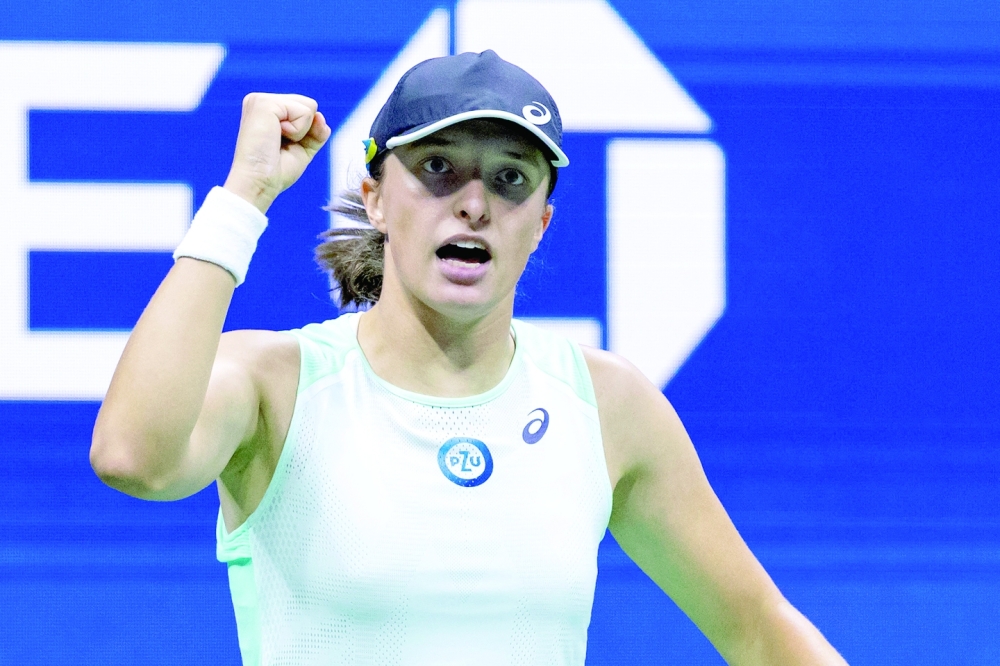 TOPSHOT - Poland's Iga Swiatek gestures after a point during her 2022 US Open Tennis tournament women's singles quarter-final match against USA's Jessica Pegula at the USTA Billie Jean King National Tennis Center in New York, on September 7, 2022. (Photo by Corey Sipkin / AFP)

