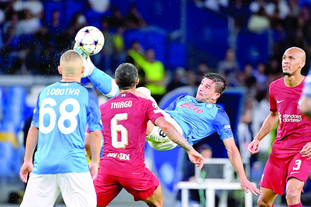 Napoli's Argentinian forward Giovanni Simeone scissor kicks the ball during the UEFA Champions League Group A first leg football match between SSC Napoli and Liverpool FC at the Diego Armando Maradona Stadium in Naples on September 7, 2022. (Photo by Alberto PIZZOLI / AFP)