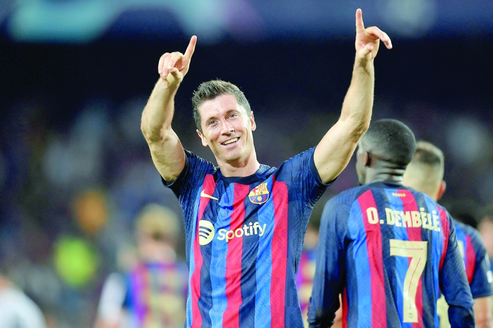 Barcelona's Polish forward Robert Lewandowski celebrates after scoring his team's third goal during the UEFA Champions League Group C first-leg football match between FC Barcelona and Viktoria Plzen, at the Camp Nou stadium in Barcelona on September 7, 2022. (Photo by Pau BARRENA / AFP)