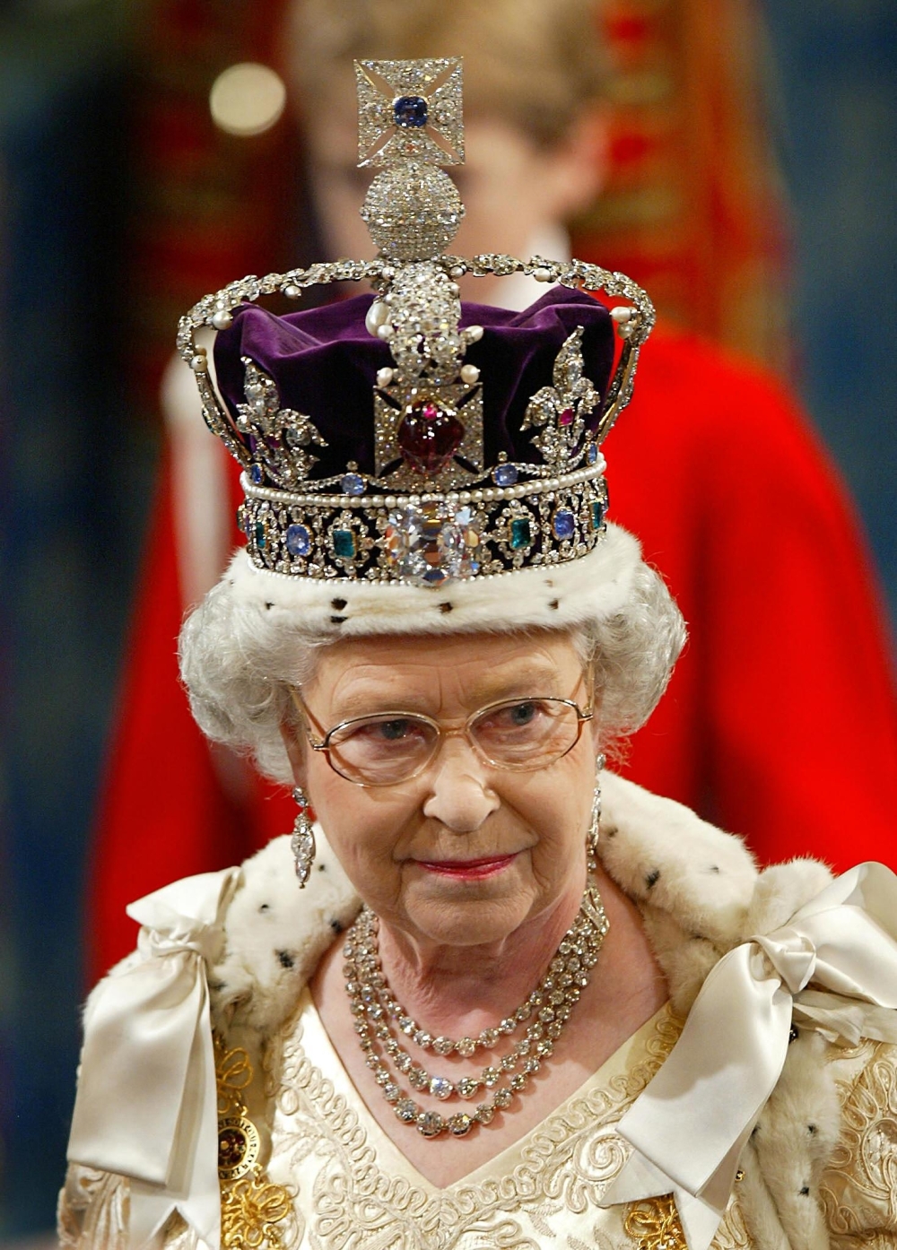 In this file photo taken on November 13, 2002 Britain's Queen Elizabeth II, wearing the Imperial Crown, walks in procession through The Royal Gallery on her way to give her speech during the ceremonial state opening of Parliament in London.   Queen Elizabeth II, the longest-serving monarch in British history and an icon instantly recognisable to billions of people around the world, has died aged 96, Buckingham Palace said on September 8, 2022.  Her eldest son, Charles, 73, succeeds as king immediately, according to centuries of protocol, beginning a new, less certain chapter for the royal family after the queen's record-breaking 70-year reign.  (Photo by Adrian DENNIS / POOL / AFP)