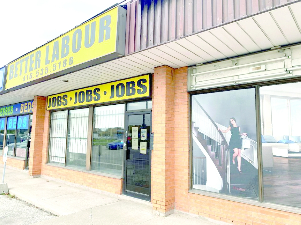 A view of an illustration outside a wood flooring sales office next to an employment agency in Toronto, Ontario, Canada. -- Reuters