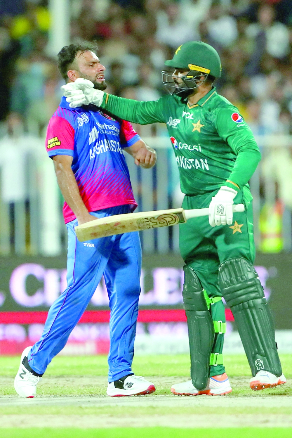 Pakistan's Asif Ali (R) and Afghanistan's Fareed Ahmad argue after a dismissal during the Asia Cup Twenty20 international cricket Super Four match between Afghanistan and Pakistan at the Sharjah Cricket Stadium in Sharjah on September 7, 2022. (Photo by SURJEET YADAV / AFP)

