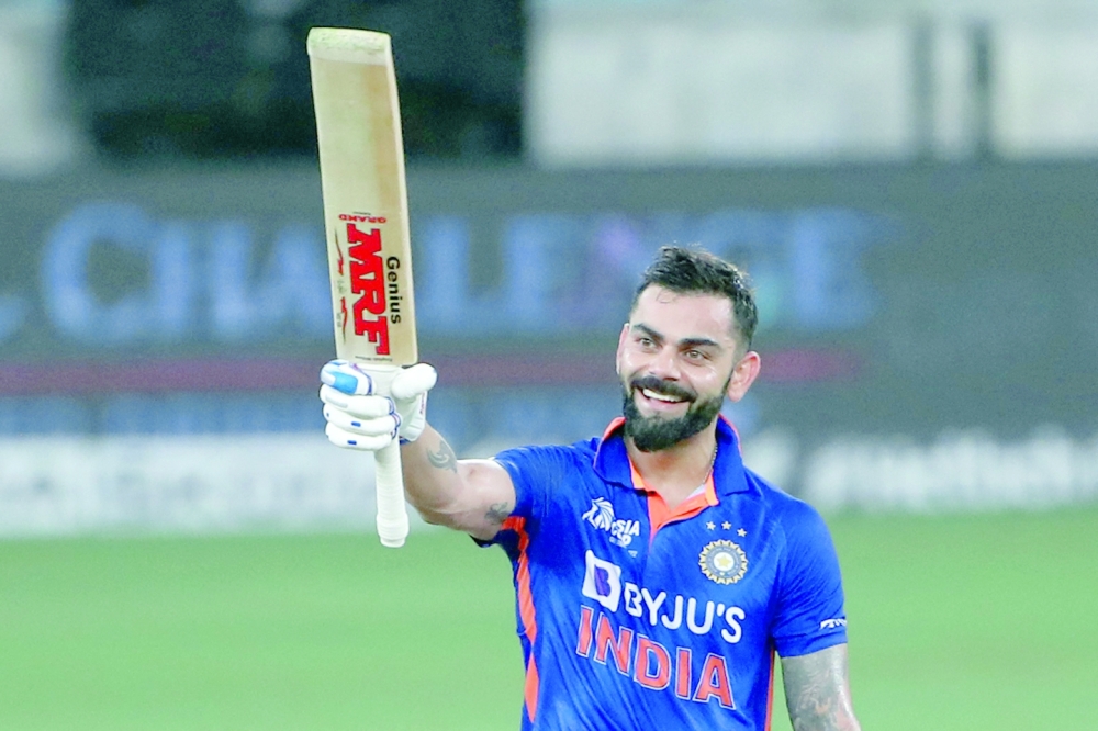 India's Virat Kohli celebrates after scoring a century (100 runs) during the Asia Cup Twenty20 international cricket Super Four match between Afghanistan and India at the Dubai International Cricket Stadium in Dubai on September 8, 2022. (Photo by SURJEET YADAV / AFP)

