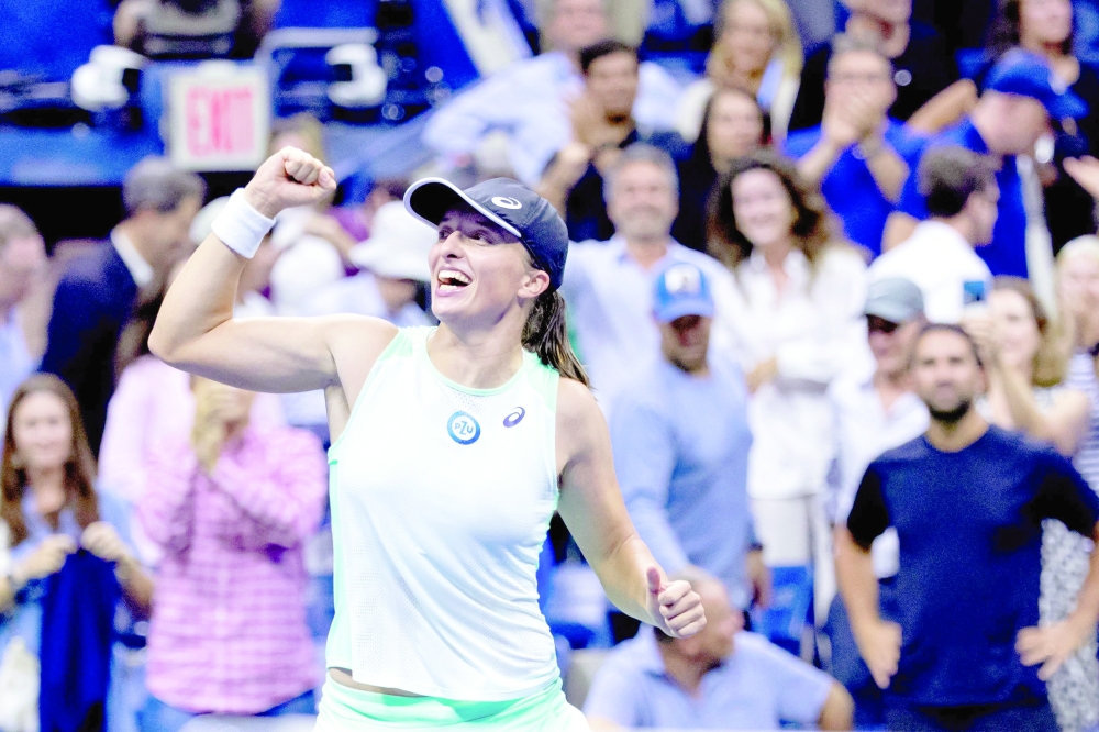 Poland's Iga Swiatek celebrates after winning against Belarus's Aryna Sabalenka during their 2022 US Open Tennis tournament women's singles semifinal match at the USTA Billie Jean King National Tennis Center in New York, on September 8, 2022. (Photo by Corey Sipkin / AFP)